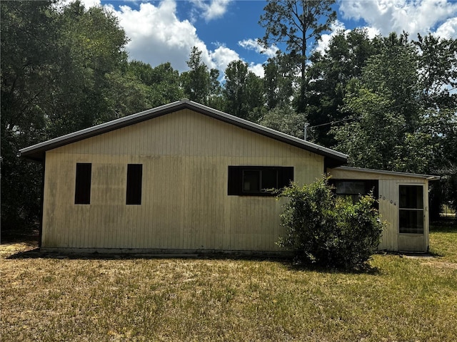 20704 SW Rainbow Lakes Blvd, Dunnellon, FL 34431 - view of home's exterior with a yard