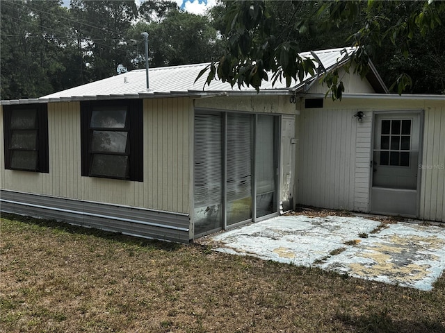 20704 SW Rainbow Lakes Blvd, Dunnellon, FL 34431 - view of side of property featuring a patio area and metal roof