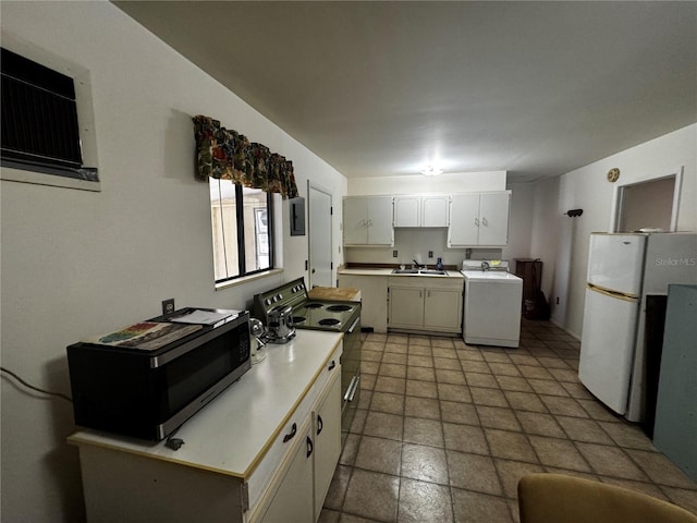 20704 SW Rainbow Lakes Blvd, Dunnellon, FL 34431 - kitchen featuring washer / dryer, stainless steel microwave, freestanding refrigerator, range with electric stovetop, and light countertops