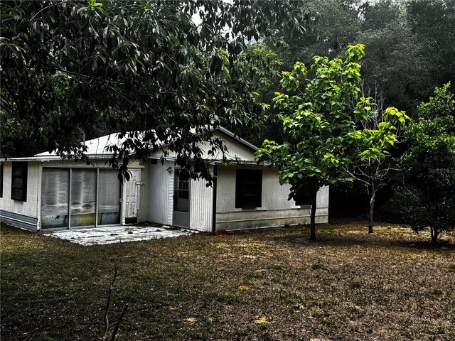 20704 SW Rainbow Lakes Blvd, Dunnellon, FL 34431 - rear view of property with a sunroom