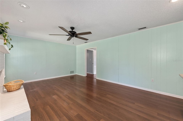 1812 SE 38th Ave, Ocala, FL 34471 - empty room featuring ceiling fan, wood finished floors, a textured ceiling, baseboards, and a fireplace