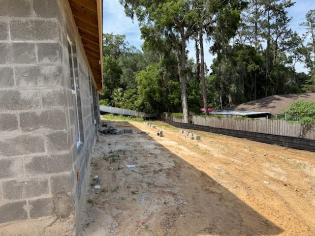 85 NW 45th Loop, Ocala, FL 34475 - view of yard featuring a garage and view of wooded area