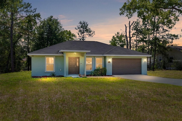 5425 Pecan Rd, Ocala, FL 34472 - single story home featuring a garage, concrete driveway, a front lawn, and stucco siding