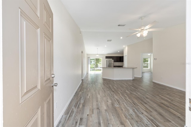 5425 Pecan Rd, Ocala, FL 34472 - unfurnished living room with light wood-style floors, ceiling fan, lofted ceiling, baseboards, and recessed lighting