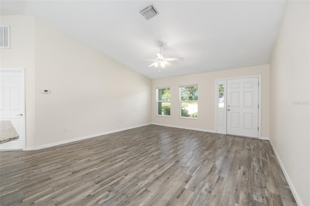 5425 Pecan Rd, Ocala, FL 34472 - unfurnished living room with lofted ceiling, ceiling fan, wood finished floors, and baseboards