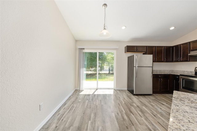 5425 Pecan Rd, Ocala, FL 34472 - kitchen with stainless steel appliances, light wood finished floors, dark brown cabinetry, baseboards, and hanging light fixtures