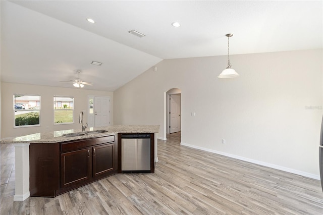 5425 Pecan Rd, Ocala, FL 34472 - kitchen featuring dishwasher, arched walkways, light wood-style floors, a sink, and open floor plan