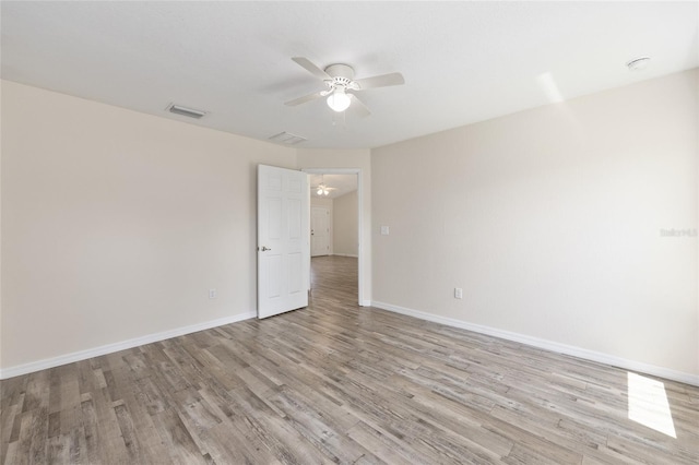 5425 Pecan Rd, Ocala, FL 34472 - empty room with ceiling fan, light wood finished floors, and baseboards