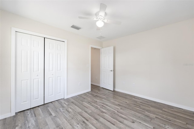 5425 Pecan Rd, Ocala, FL 34472 - unfurnished bedroom with wood finished floors, baseboards, a closet, and ceiling fan