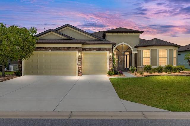 9777 SW 63rd Loop, Ocala, FL 34481 - view of front of property featuring a garage, a lawn, stucco siding, concrete driveway, and stone siding