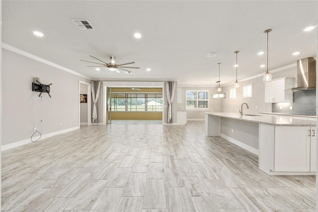 9777 SW 63rd Loop, Ocala, FL 34481 - unfurnished living room with a sink, crown molding, healthy amount of natural light, recessed lighting, and a ceiling fan