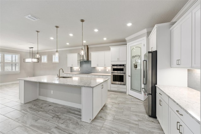 9777 SW 63rd Loop, Ocala, FL 34481 - kitchen with appliances with stainless steel finishes, ornamental molding, a sink, tasteful backsplash, and wall chimney range hood