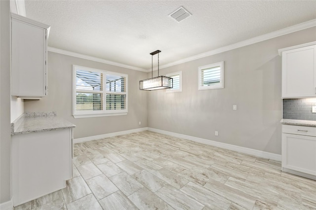 9777 SW 63rd Loop, Ocala, FL 34481 - unfurnished dining area with crown molding, healthy amount of natural light, a textured ceiling, and baseboards