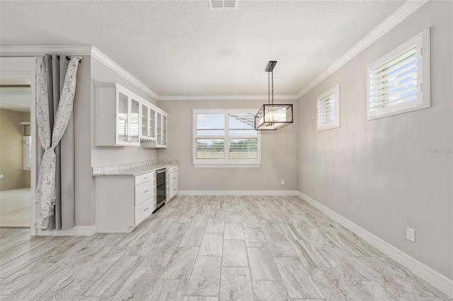 9777 SW 63rd Loop, Ocala, FL 34481 - kitchen featuring beverage cooler, ornamental molding, light countertops, glass insert cabinets, and white cabinetry