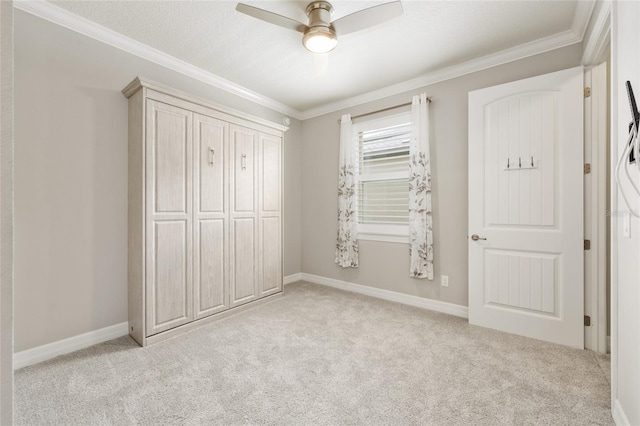 9777 SW 63rd Loop, Ocala, FL 34481 - unfurnished bedroom with light colored carpet, crown molding, baseboards, ceiling fan, and a closet
