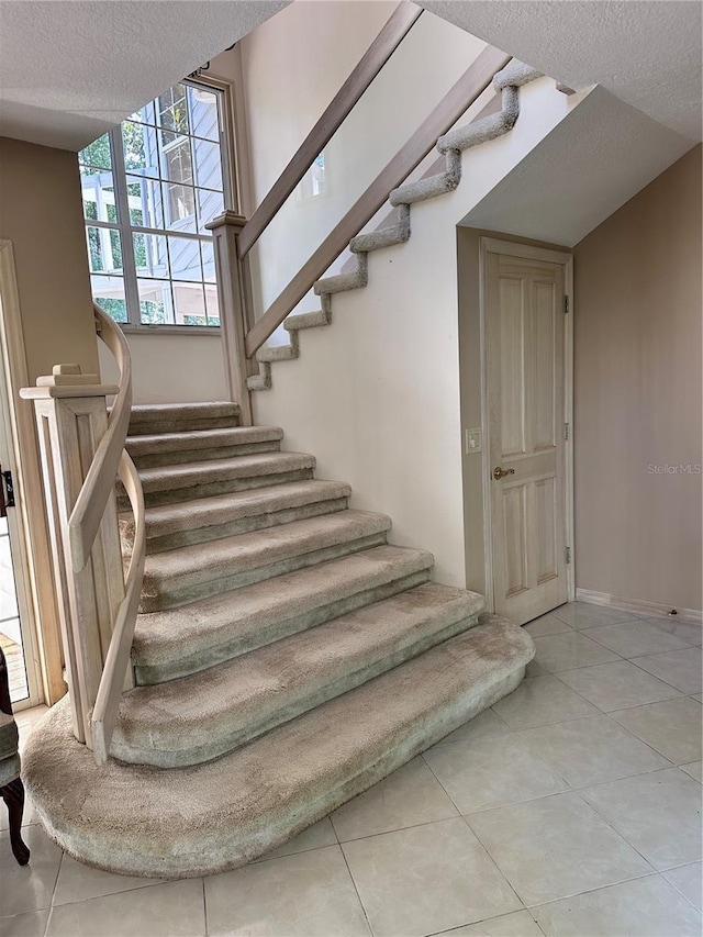 4305 SW 20th Ave, Ocala, FL 34471 - stairs with a textured ceiling, tile patterned floors, and baseboards