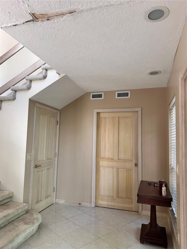 4305 SW 20th Ave, Ocala, FL 34471 - foyer entrance featuring stairway, light tile patterned floors, a textured ceiling, and baseboards