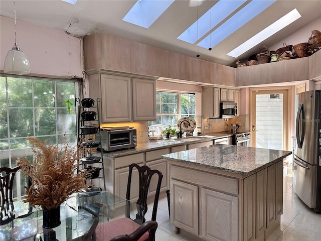 4305 SW 20th Ave, Ocala, FL 34471 - kitchen featuring a skylight, appliances with stainless steel finishes, a sink, light tile patterned flooring, and lofted ceiling