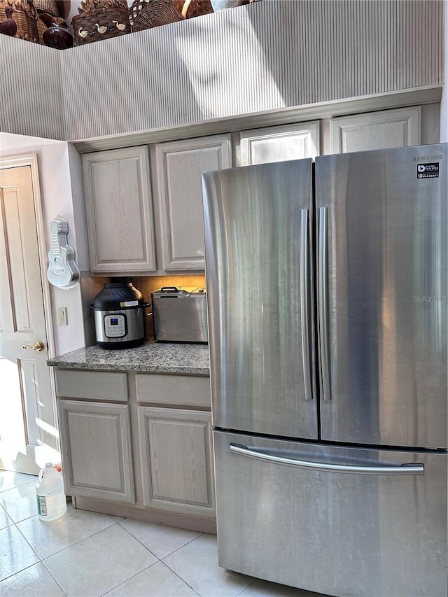 4305 SW 20th Ave, Ocala, FL 34471 - kitchen with freestanding refrigerator, light tile patterned flooring, and light stone counters