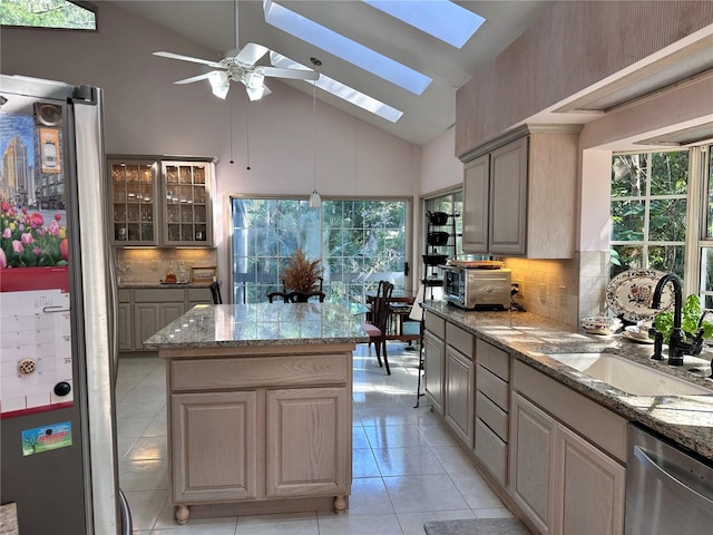 4305 SW 20th Ave, Ocala, FL 34471 - kitchen with stainless steel appliances, a sink, a skylight, high vaulted ceiling, and tasteful backsplash