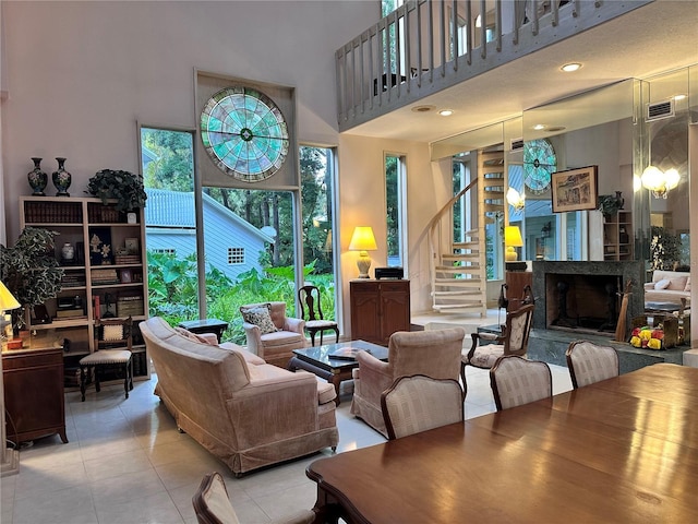 4305 SW 20th Ave, Ocala, FL 34471 - tiled living area with a high ceiling, stairs, and a fireplace