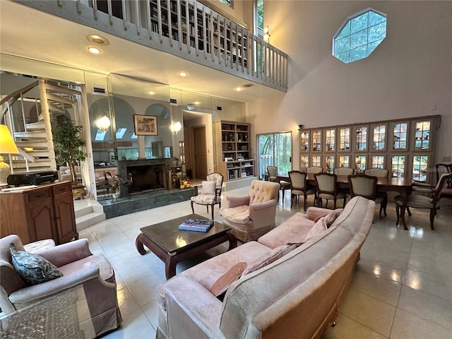 4305 SW 20th Ave, Ocala, FL 34471 - living room featuring a towering ceiling, light tile patterned flooring, a fireplace, and stairs