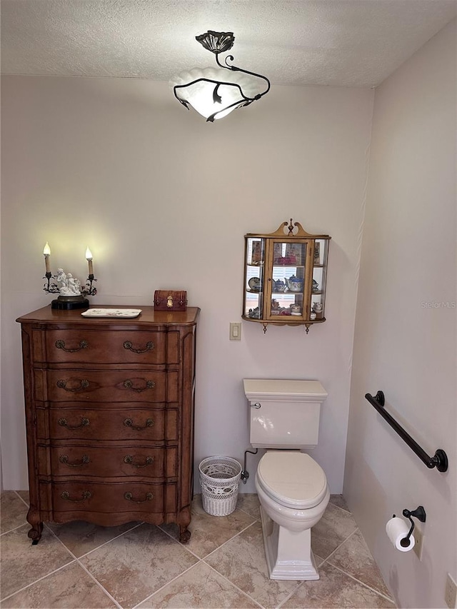 4305 SW 20th Ave, Ocala, FL 34471 - half bathroom featuring toilet, tile patterned floors, vanity, and a textured ceiling