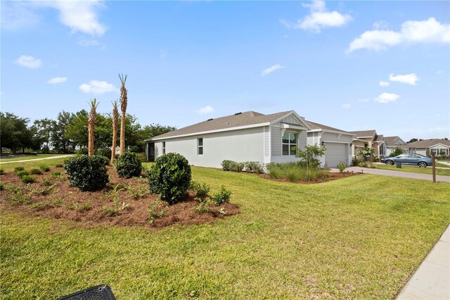 4892 NW 39th Loop, Ocala, FL 34482 - view of home's exterior featuring a garage, asphalt driveway, and a lawn