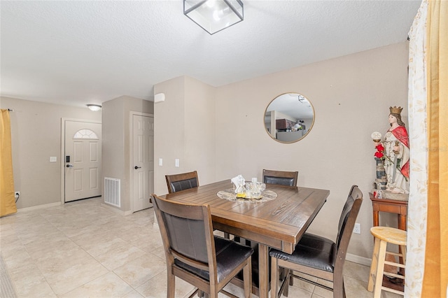 2690 SW 154th Ln, Ocala, FL 34473 - dining space featuring light tile patterned flooring, baseboards, and a textured ceiling