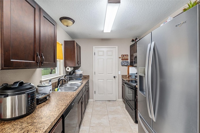 2690 SW 154th Ln, Ocala, FL 34473 - kitchen featuring appliances with stainless steel finishes, a sink, a textured ceiling, dark brown cabinets, and light tile patterned flooring