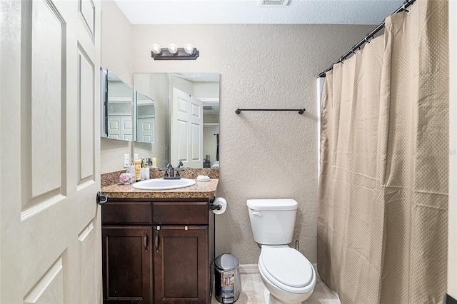 2690 SW 154th Ln, Ocala, FL 34473 - bathroom featuring vanity, toilet, a textured wall, and curtained shower