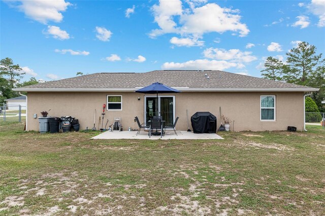2690 SW 154th Ln, Ocala, FL 34473 - back of house featuring stucco siding and a patio area