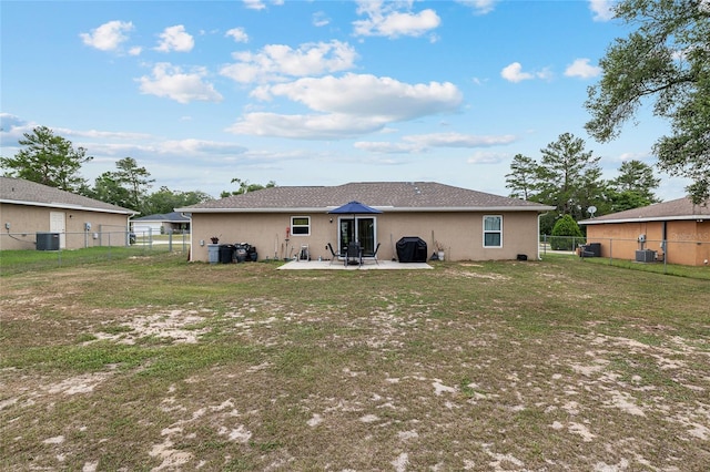 2690 SW 154th Ln, Ocala, FL 34473 - back of property with central air condition unit, a patio, and stucco siding