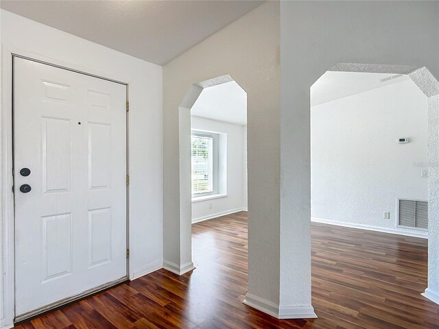12352 SE 86th Ct, Belleview, FL 34420 - entrance foyer with wood finished floors, arched walkways, and baseboards