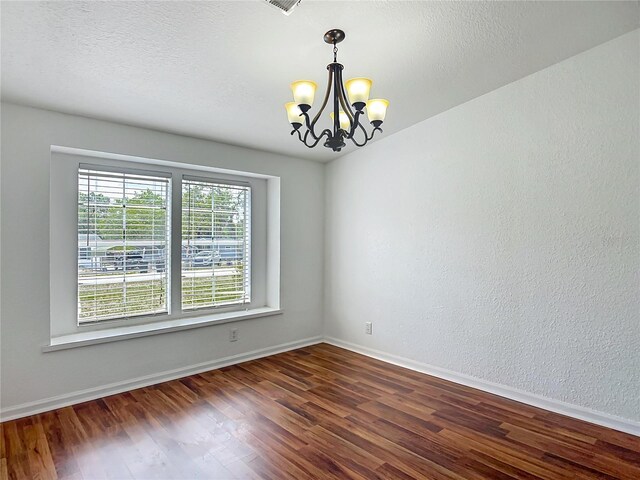 12352 SE 86th Ct, Belleview, FL 34420 - unfurnished room with a chandelier, dark wood-type flooring, and baseboards