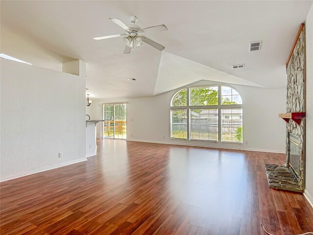 12352 SE 86th Ct, Belleview, FL 34420 - unfurnished living room with a stone fireplace, a ceiling fan, wood finished floors, lofted ceiling, and baseboards