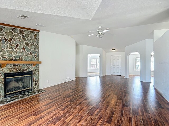 12352 SE 86th Ct, Belleview, FL 34420 - unfurnished living room with lofted ceiling, ceiling fan, wood finished floors, arched walkways, and a fireplace