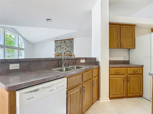 12352 SE 86th Ct, Belleview, FL 34420 - kitchen with dishwasher, a sink, brown cabinets, lofted ceiling, and light tile patterned floors