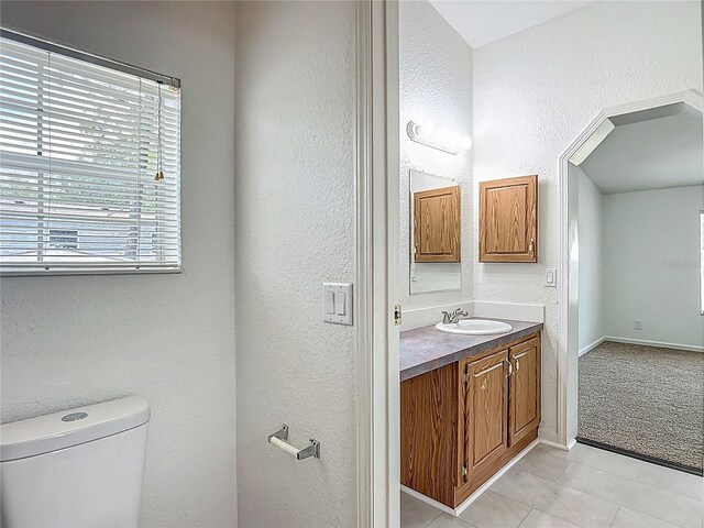 12352 SE 86th Ct, Belleview, FL 34420 - bathroom featuring toilet, vanity, tile patterned flooring, a textured wall, and baseboards
