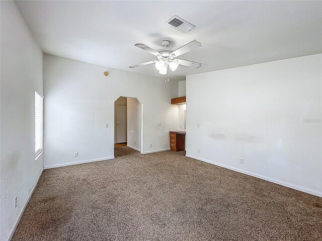 12352 SE 86th Ct, Belleview, FL 34420 - unfurnished room featuring a ceiling fan, carpet, arched walkways, and baseboards