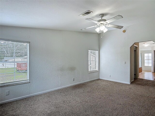 12352 SE 86th Ct, Belleview, FL 34420 - carpeted spare room with a ceiling fan, a textured wall, arched walkways, and baseboards