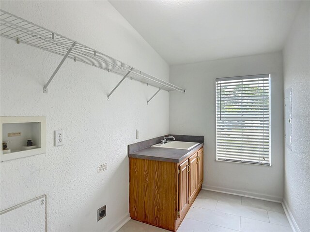 12352 SE 86th Ct, Belleview, FL 34420 - washroom with hookup for an electric dryer, cabinet space, light tile patterned floors, baseboards, and hookup for a washing machine