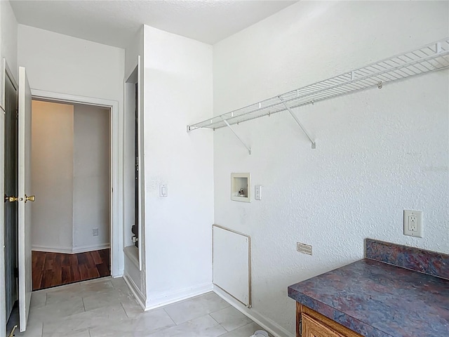 12352 SE 86th Ct, Belleview, FL 34420 - laundry room with hookup for a washing machine, light tile patterned flooring, and baseboards