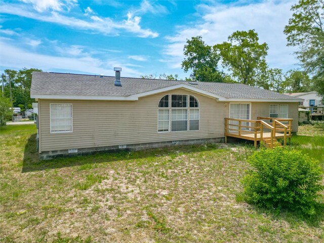 12352 SE 86th Ct, Belleview, FL 34420 - rear view of house featuring a deck, a shingled roof, and crawl space