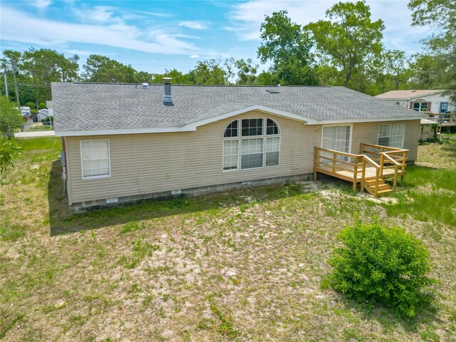 12352 SE 86th Ct, Belleview, FL 34420 - back of property with a shingled roof, a deck, and crawl space