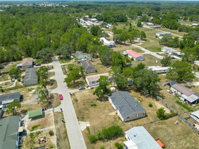 12352 SE 86th Ct, Belleview, FL 34420 - aerial overview of property's location featuring nearby suburban area and a heavily wooded area