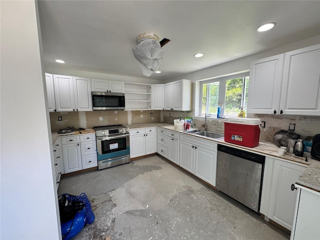 4000 SW 6th Ave, Ocala, FL 34471 - kitchen with stainless steel appliances, a sink, white cabinets, decorative backsplash, and open shelves