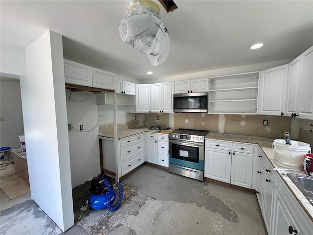 4000 SW 6th Ave, Ocala, FL 34471 - kitchen with appliances with stainless steel finishes, white cabinetry, concrete flooring, open shelves, and recessed lighting