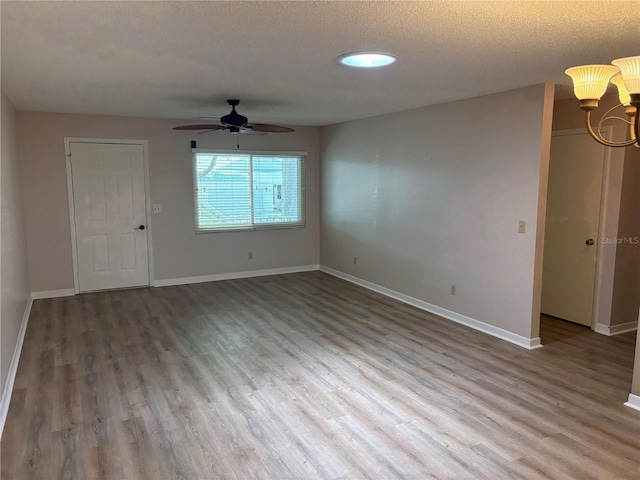 9801 SW 88th Ter Unit B, Ocala, FL 34481 - spare room with a ceiling fan, wood finished floors, baseboards, and a textured ceiling