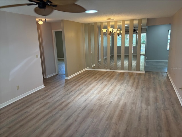 9801 SW 88th Ter Unit B, Ocala, FL 34481 - empty room featuring a chandelier, ceiling fan, wood finished floors, and baseboards
